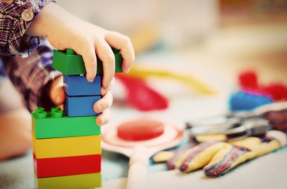 A child playing with coloured building blocks