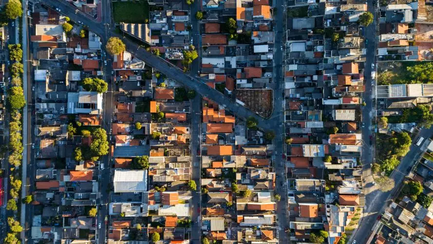 A neighbourhood of buildings seen from above, with two main streets converging in the middle. Credit: gustavofrazao / Getty Images-695509606