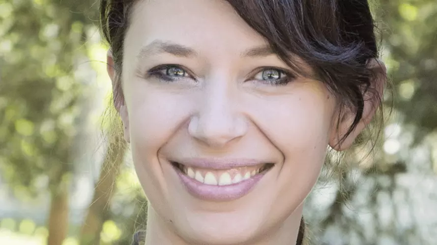 Jane Gingrich's headshot shows her with her hair tied up, smiling at the camera.