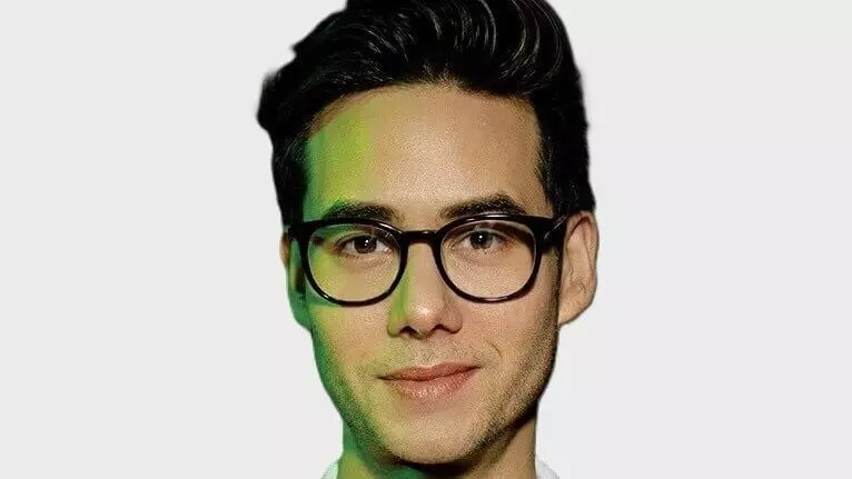 Ryan Velandria Mccarthy wears a white polo shirt and glasses. 