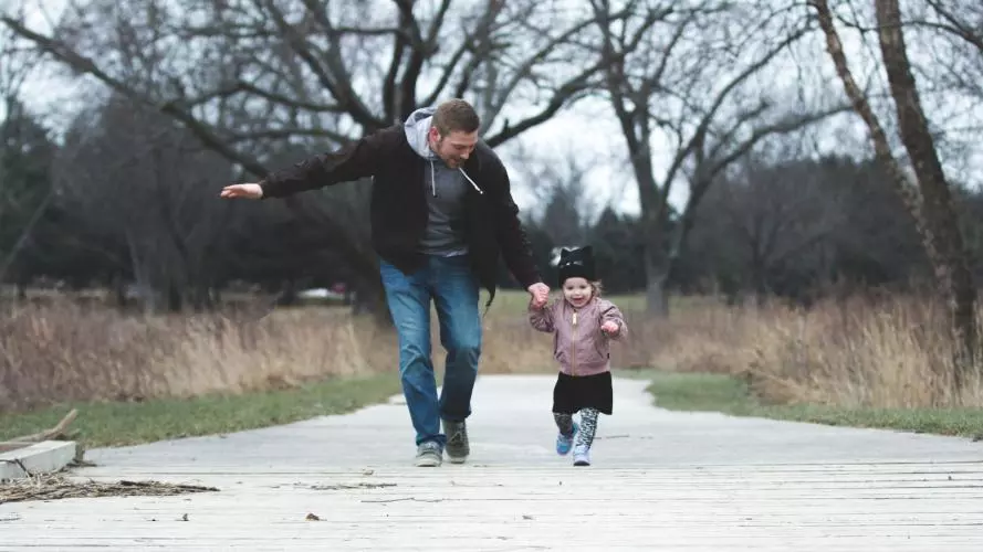 Father and daughter enjoying a walk in the park