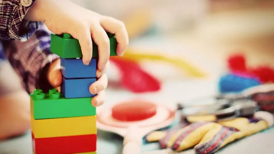 A child playing with coloured building blocks