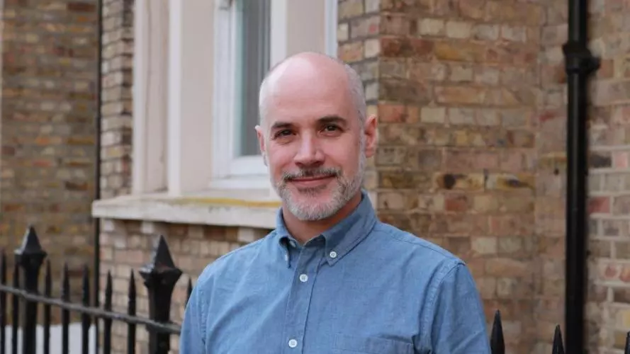 jamie lachman is wearing a blue top, smiling directly at the camera.