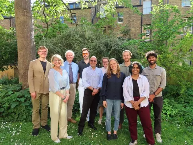 10 people, including panellists and students, who took part in the policy exercise, looking directly at the camera.