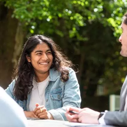 DSPI students in a garden smiling and chatting 