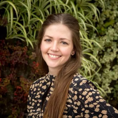 Ana Restrepo saenz has long hair wearing a floral top smiling directly at the camera.