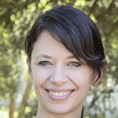 Jane Gingrich's headshot shows her with her hair tied up, smiling at the camera.