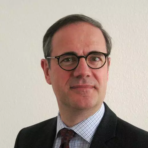 Man with dark grey wearing dark rimmed glasses and dark jacket