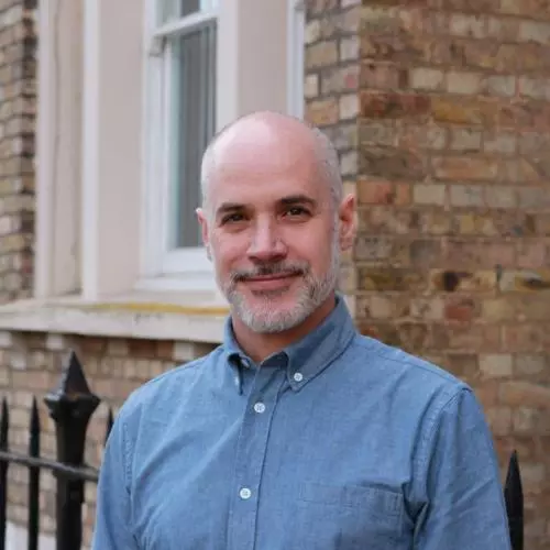 jamie lachman is wearing a blue top, smiling directly at the camera.