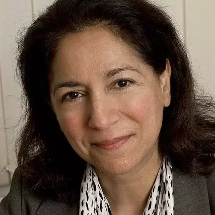 Rebecca Surender has long black hair and is wearing a brown jacket with white and brown scarf.