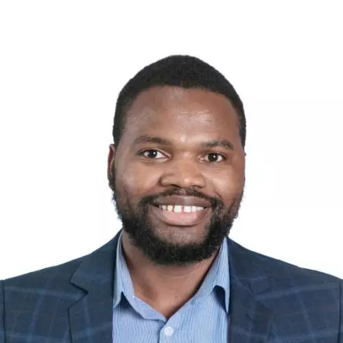 Dr Siyanai Zhou is wearing a dark blue with stripes jacket, with a blue shirt with short afro hair, smiling at the camera.
