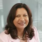 Yvonne has shoulder-length brunette hair. She is wearing a pink blazer and pearl necklace
