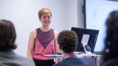 DSPI undergraduate students in a lecture, with the tutor standing at the front