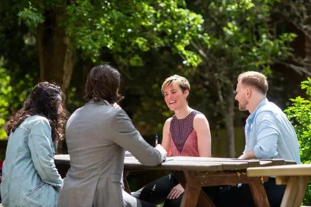 DSPI students chatting around a table at Barnett House