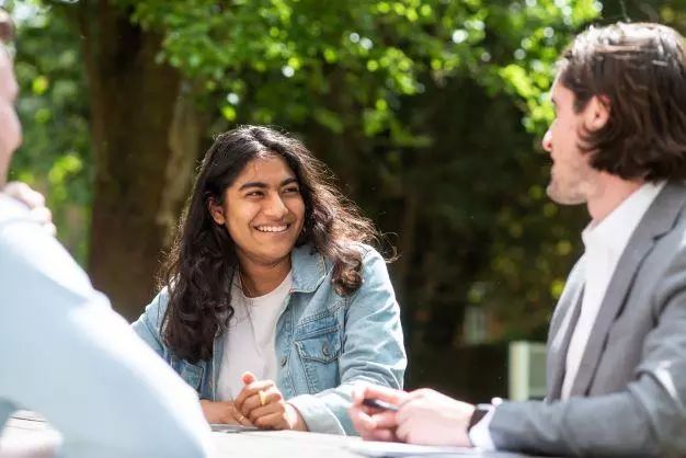 DSPI students in a garden smiling and chatting 