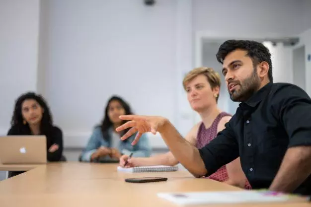 DSPI students having a discussion around a table at Barnett House