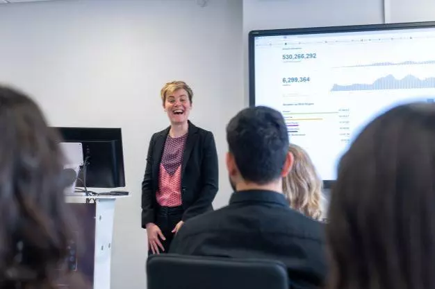DSPI staff member at front of a lecture room with students