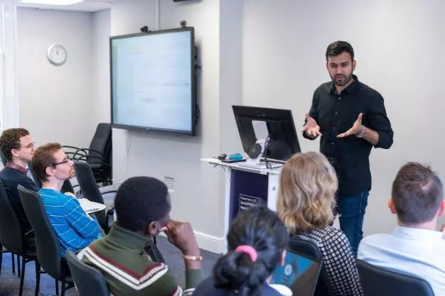 DSPI students at a lecture with a speaker at the front